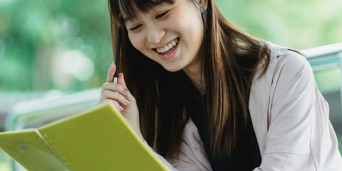 A person enjoying a book, captivated by a humorous passage that brightens their day.