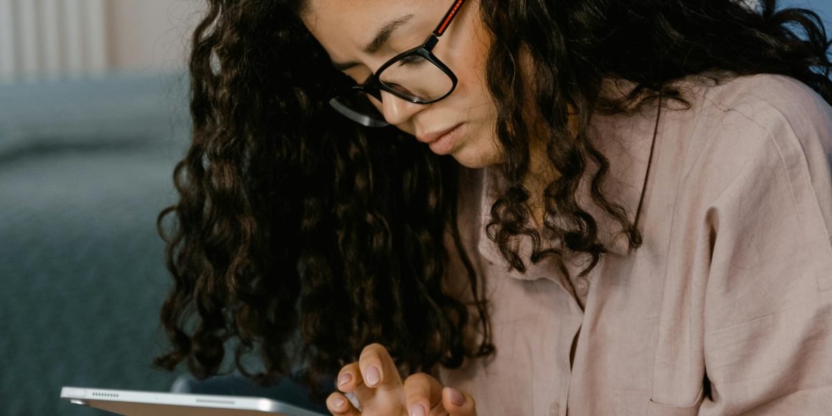 A person looking critically at a screen, embodying the struggle to find genuinely humorous content amidst a flood of misleading titles.