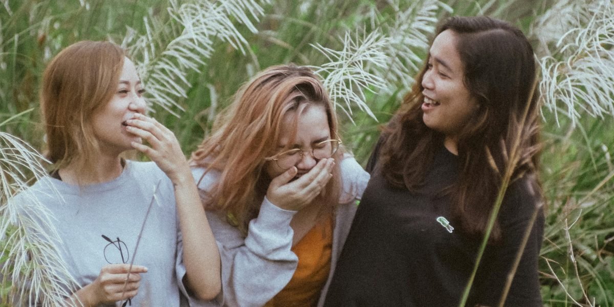 People smiling and genuinely laughing, illustrating the joy and benefits of humor in daily life.