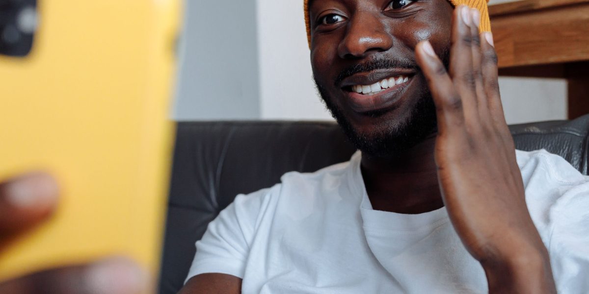 A person engrossed in watching humorous content on a mobile device, reflecting the rise of digital comedians.