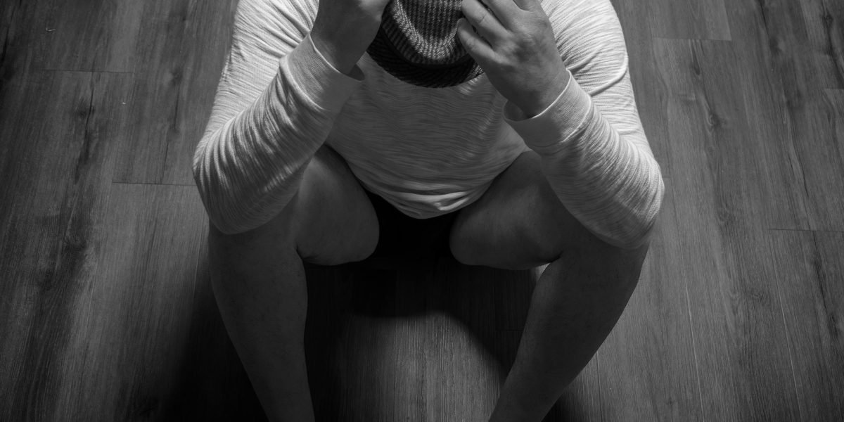 A person experiencing deep sadness, reflecting the emotional intensity of heartbreak.