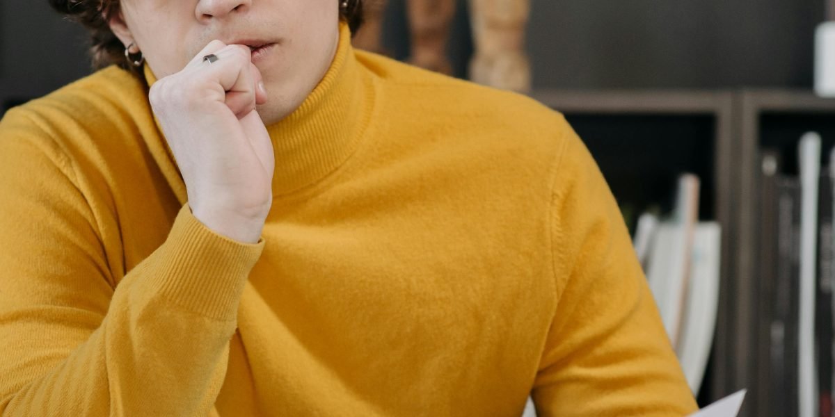 A person contemplating a serious choice, symbolizing the pivotal decisions characters face.