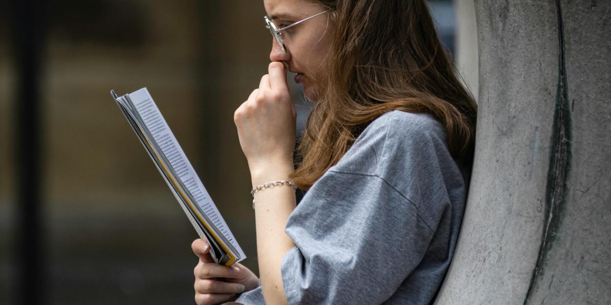A reader completely absorbed in a thrilling mystery novel, unable to put it down.